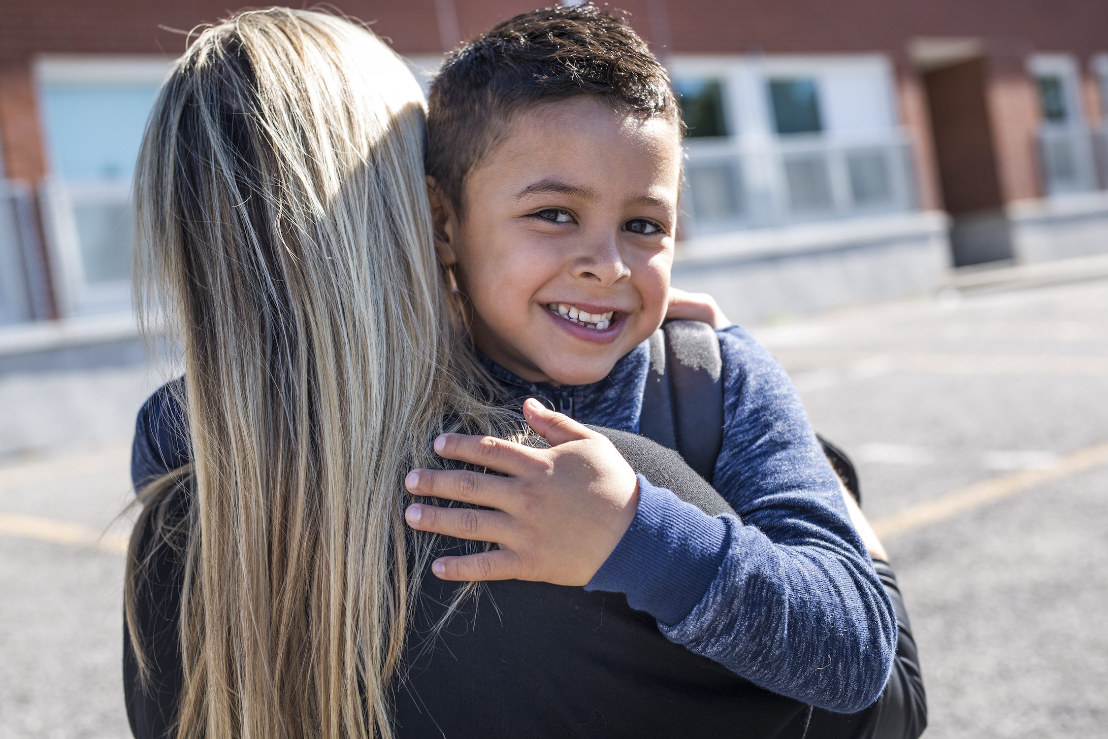 Boy and his mother hugging