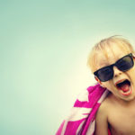Excited Child in Beach Towel on Summer Day