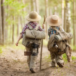 Boys on a forest road with backpacks