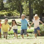 Group Of Children Running In Park