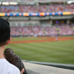 Young baseball fan watches the major league baseball game