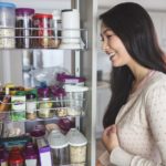 Young woman looking into the storage cabinet