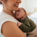 Mother putting her baby to sleep