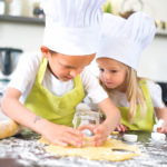 young kids happy childrens family preparing funny cookies in kitchen at home