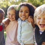 Four kids hanging out together in the garden