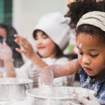 Group diversity kids girl making cake bakery in kitchen