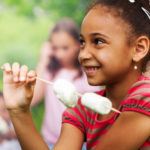 Portrait of African girl and marshmallow stick