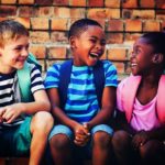 Happy children sitting on steps