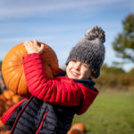 Boy selecting the perfect pumpkin