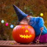 Kids carving pumpkin at Halloween