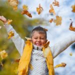 Adorable boy in autumn park