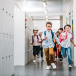 pupils running through school corridor
