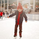 Happy boy with red hat, skating during the day