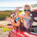 Portrait of a smiling family with two children at beach in the c