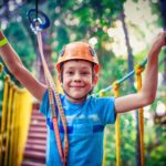 happy boy on the zip line. proud of his courage the child in the