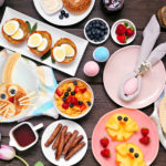 Fun Easter breakfast or brunch table scene. Top down view on a d