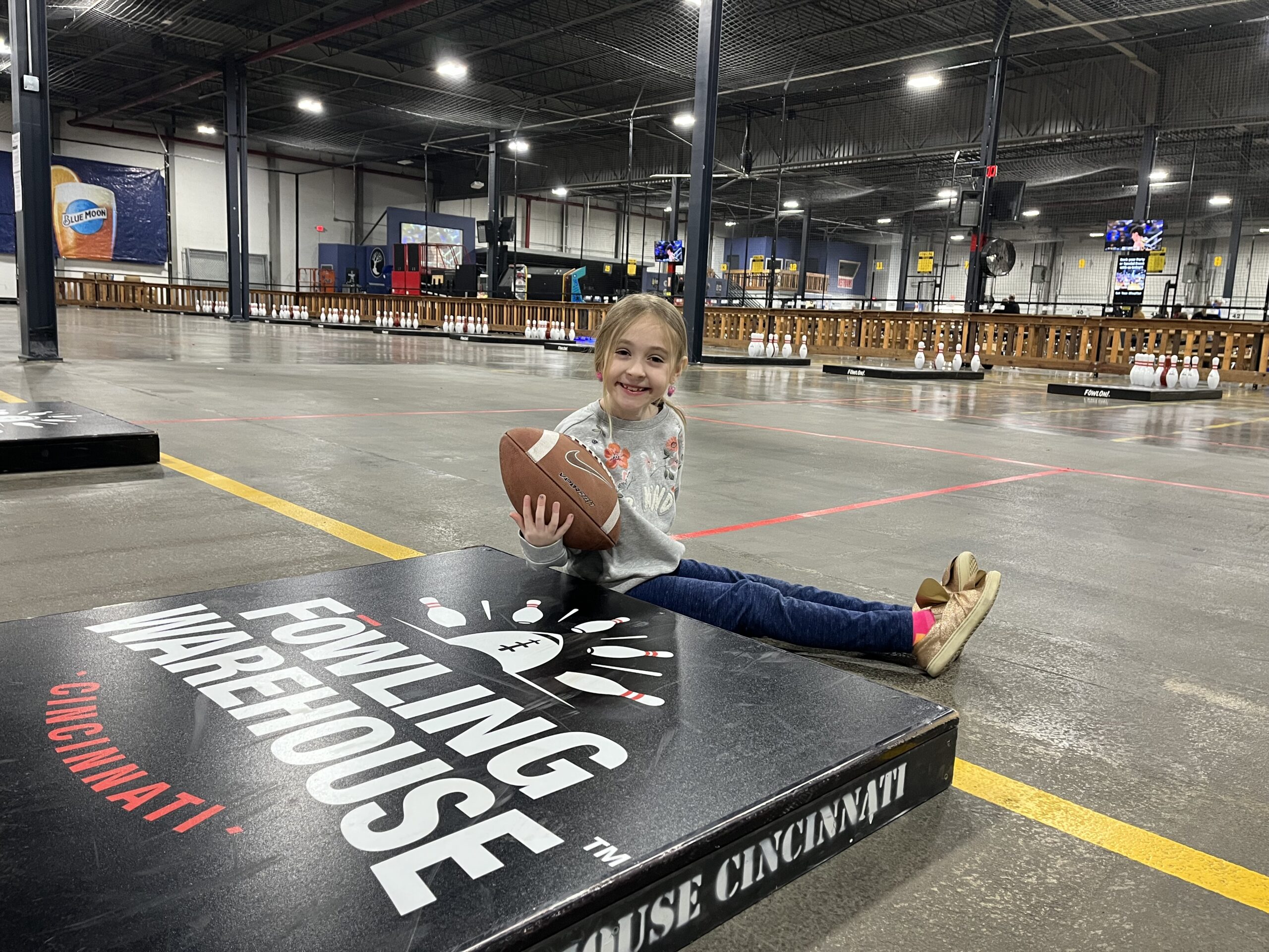 girl with football at fowling warehouse