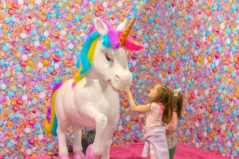 little girl with a unicorn at unicorn world
