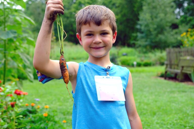 boy with carrot at gorman farm