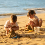 Kids making sand castle on the beach