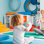 Boy playing with his therapist