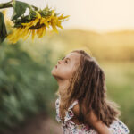 Child and sunflower, summer, nature and fun. Summer holiday.