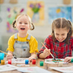Happy kids are painting at home.