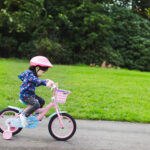 toddler girl riding bicycle in spring countryside park,Northern Ireland