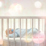 Cute little baby sleeping in cradle at home
