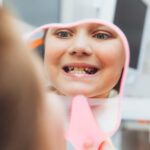 The dentist examines the teeth of a boy of 13 years old in the clinic. pediatric dentistry
