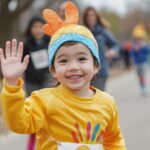 A child running in the Turkey Trot, wearing a turkey costume and waving to the crowd