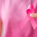 October Breast Cancer Awareness month, Woman in pink T- shirt wi