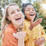 Adoption, mother and girl outdoor, smile or happy being loving, bonding or happy together. Portrait, adopted child or black girl with foster mother, happiness or love for care, relax and quality time