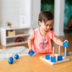 Toddler Girl Playing and Exploring with Montessori Lessons