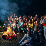 Children singing near camp fire.