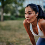Asian woman taking a moment to catch her breath after workout in