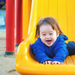 Toddler boy playing on the playground