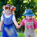 Kids in Bavarian costumes in wheat field