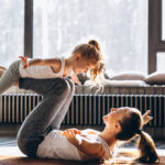 Mother and daughter yoga at home